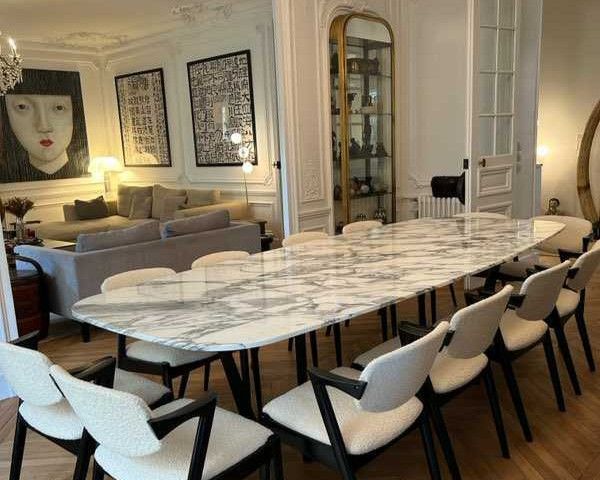 Table à manger à plateau blanc en marbre Arabescato et piètement noir, dans une salle à manger